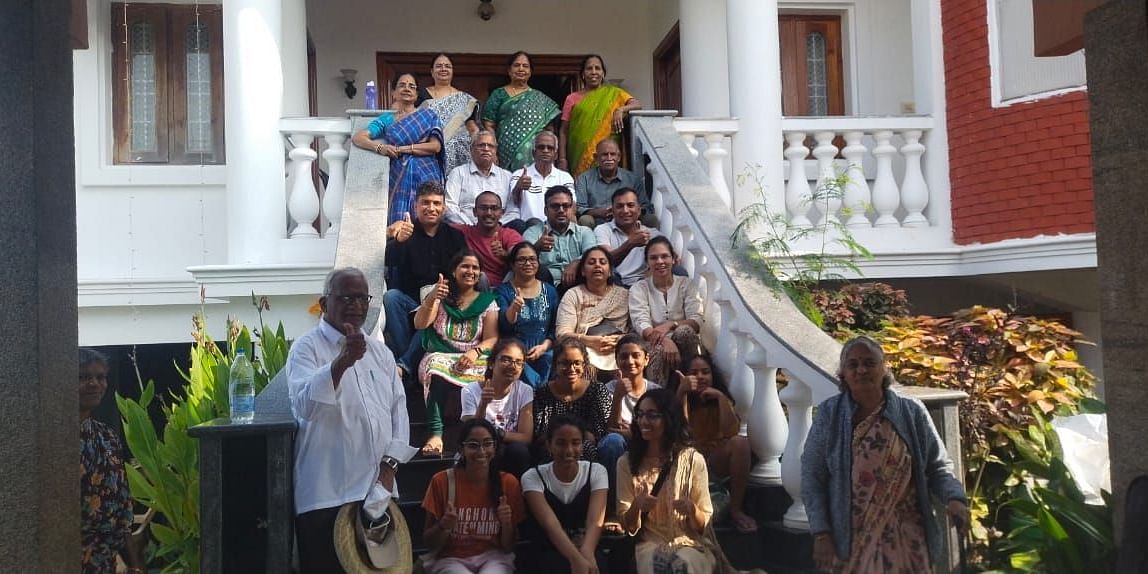 Image of a group of people sitting on the stairs and posing for a photo at Villa Serenity Le Sejour Pondicherry.