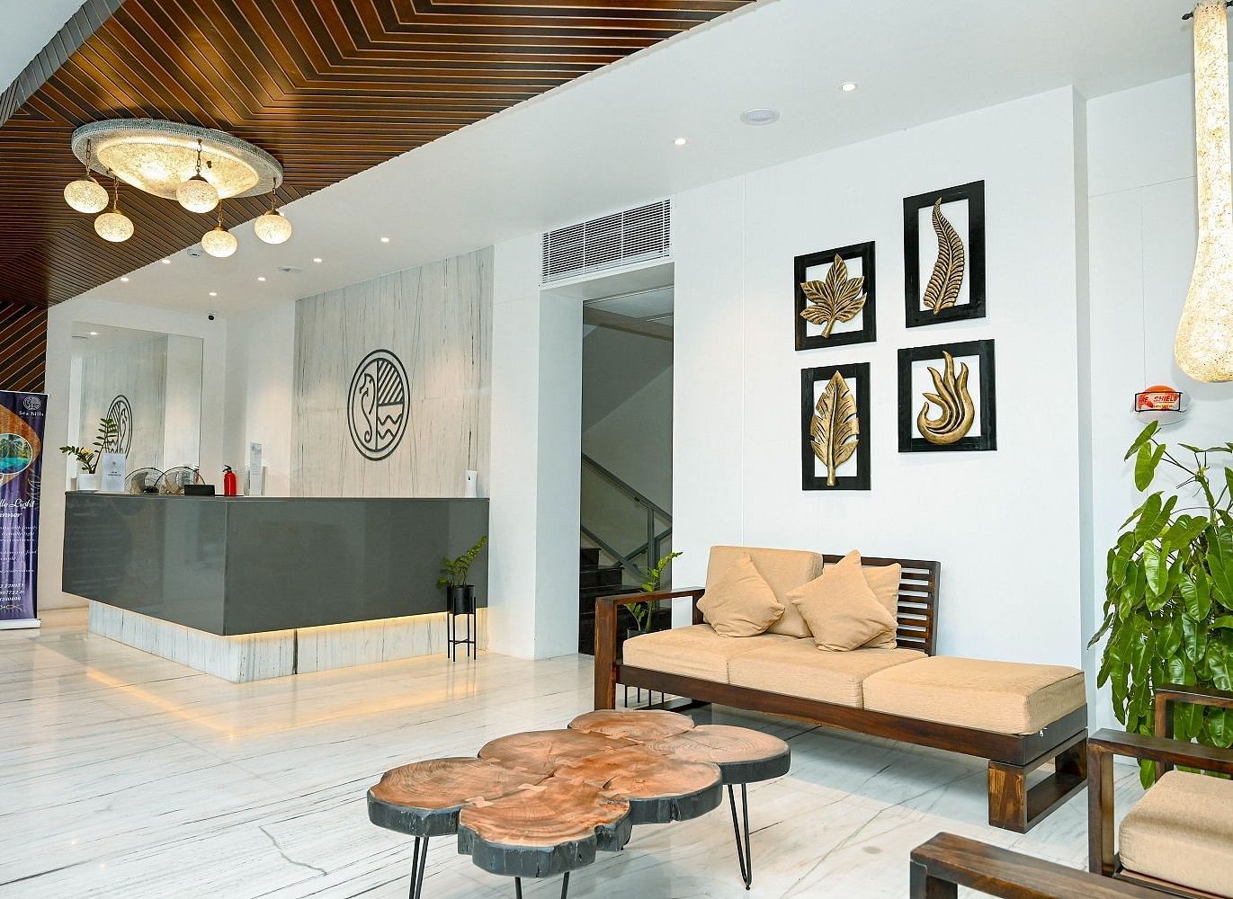 A chic hotel reception with modern furniture, decorative lighting, and wall art - Sea Hills Hotels, Sri Vijayapuram (Port Blair)