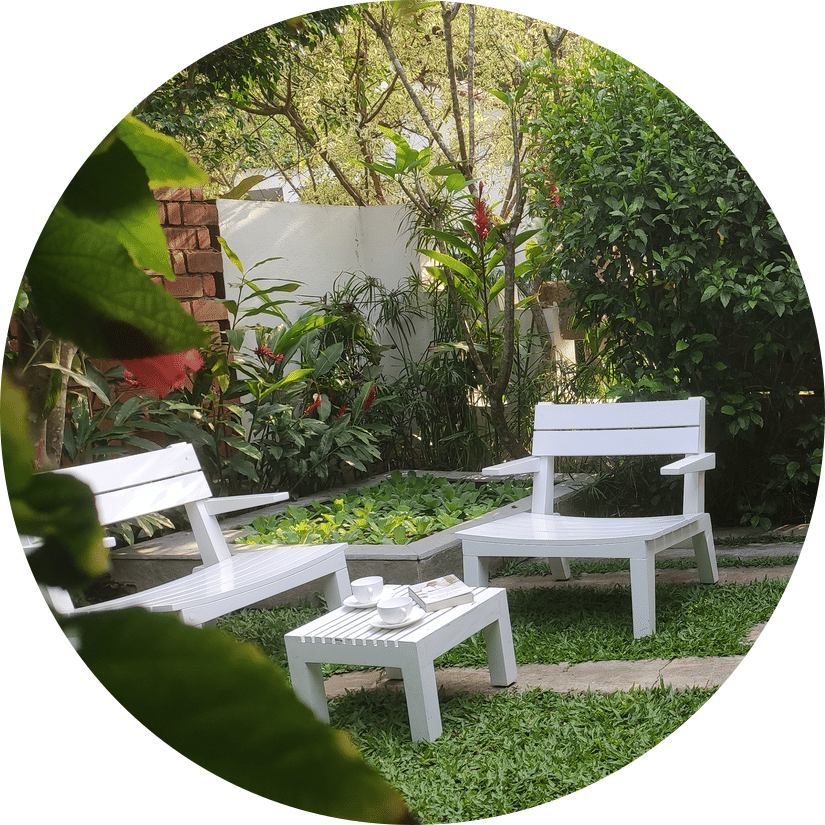 White garden chairs and table outdoors - Amanvana Spa Resort, Coorg - Luxury Resort