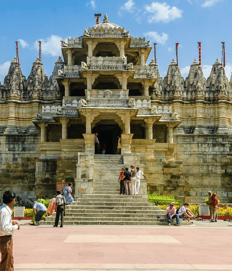 Front view of the Ranakpur Jain Temple showcasing its grand entrance, ornate marble architecture, and visitors.