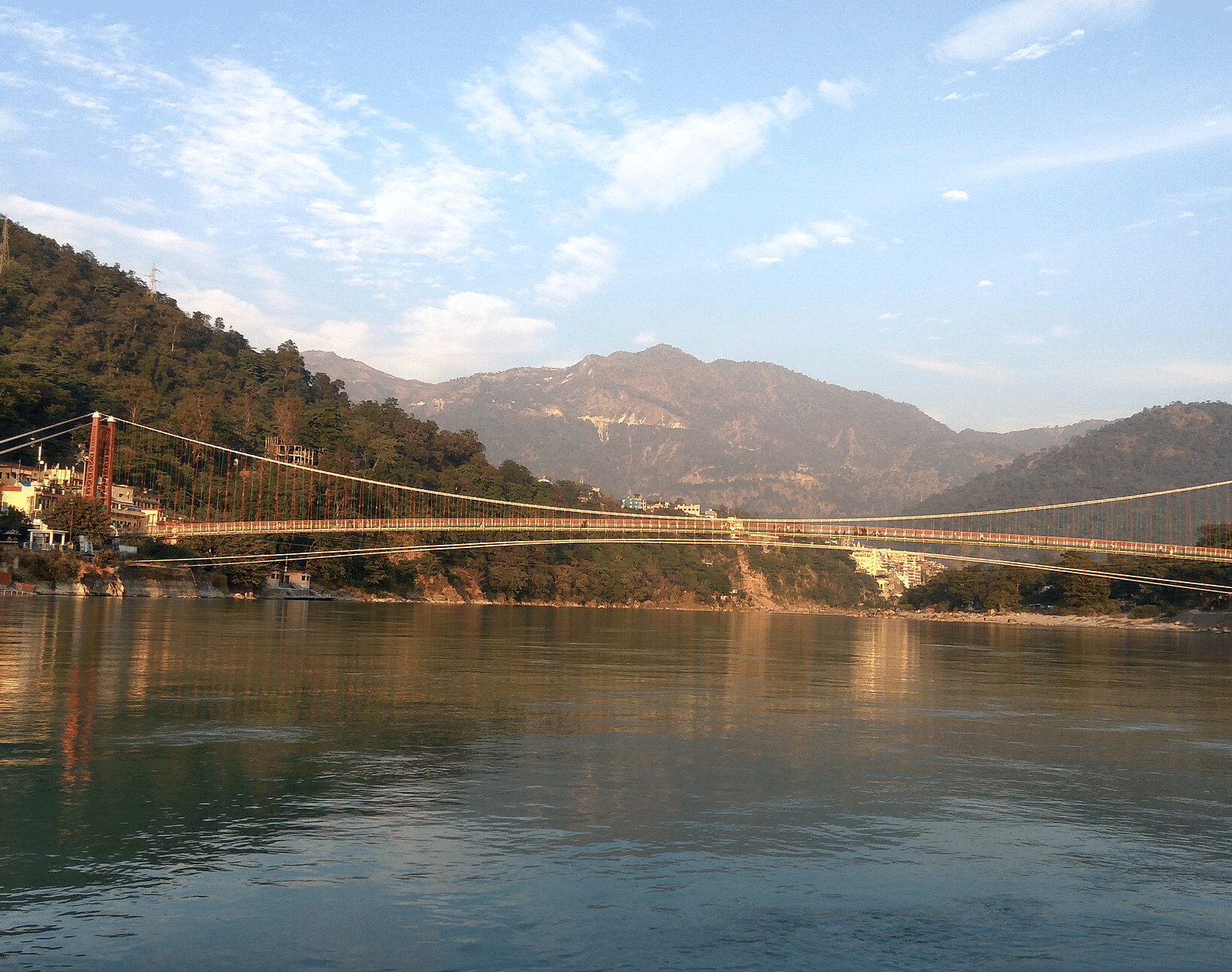A picture of a lakefront with mountains in the background captured in the day time.