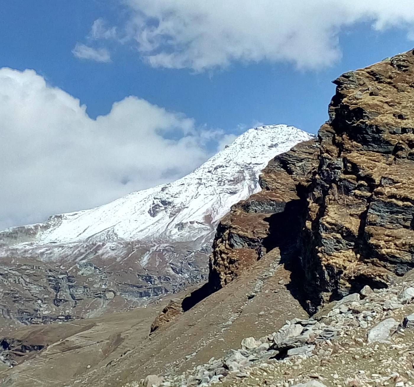 Rohtang Pass with rocks and a snow capped mountain in the background