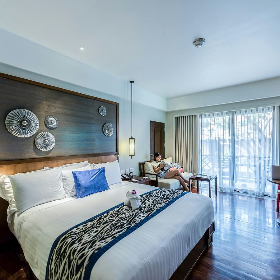 alt-text Hotel Room with large bed and furniture arranged artistically