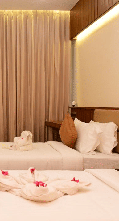 Side view of executive room with two beds at TGI Felicity