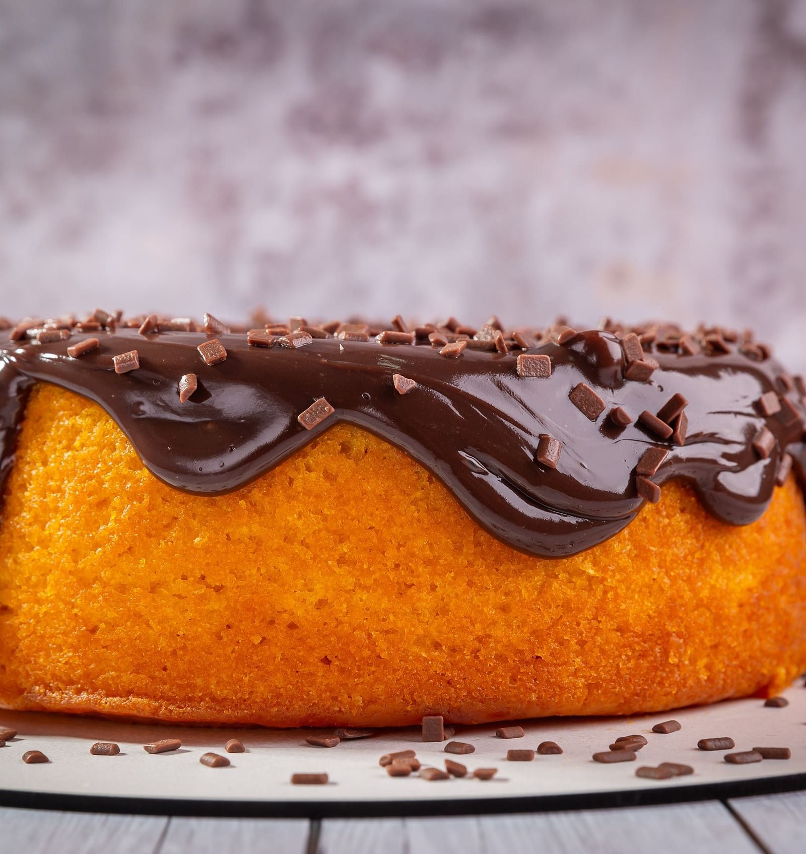 image of a cake with melted chocolate on top and toppings made of chocolate