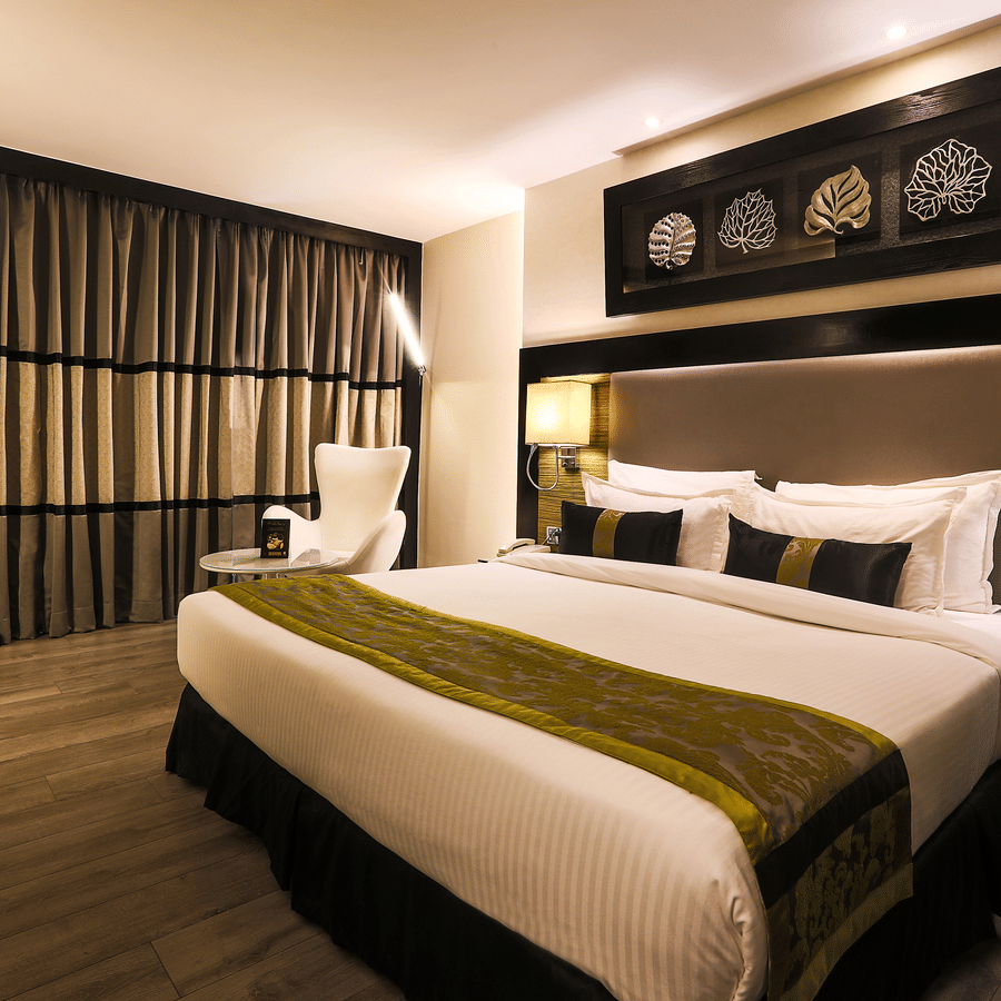 The Empresa Boutique Hotel - the king size bed offered by the Deluxe Room in Andheri