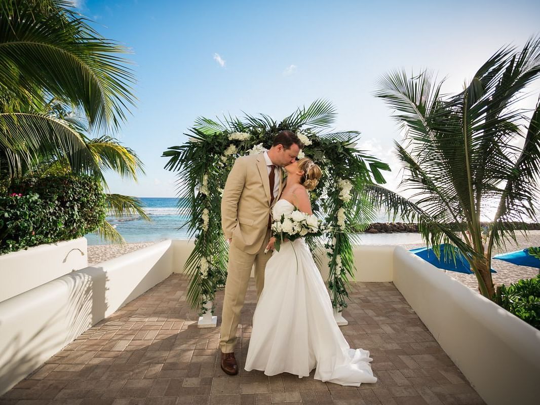 A newly wed couple kissing - The Soco Hotel Barbados