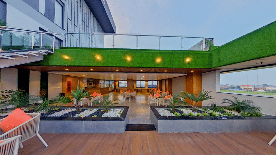 The lounge area of Distil Bar featuring chairs arranged on a wooden floor | Lords CBC Plaza, Chitwan
