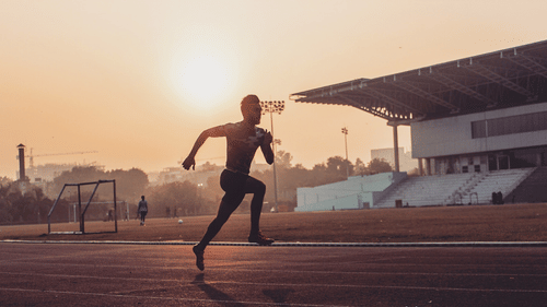 Athlete running on a track field