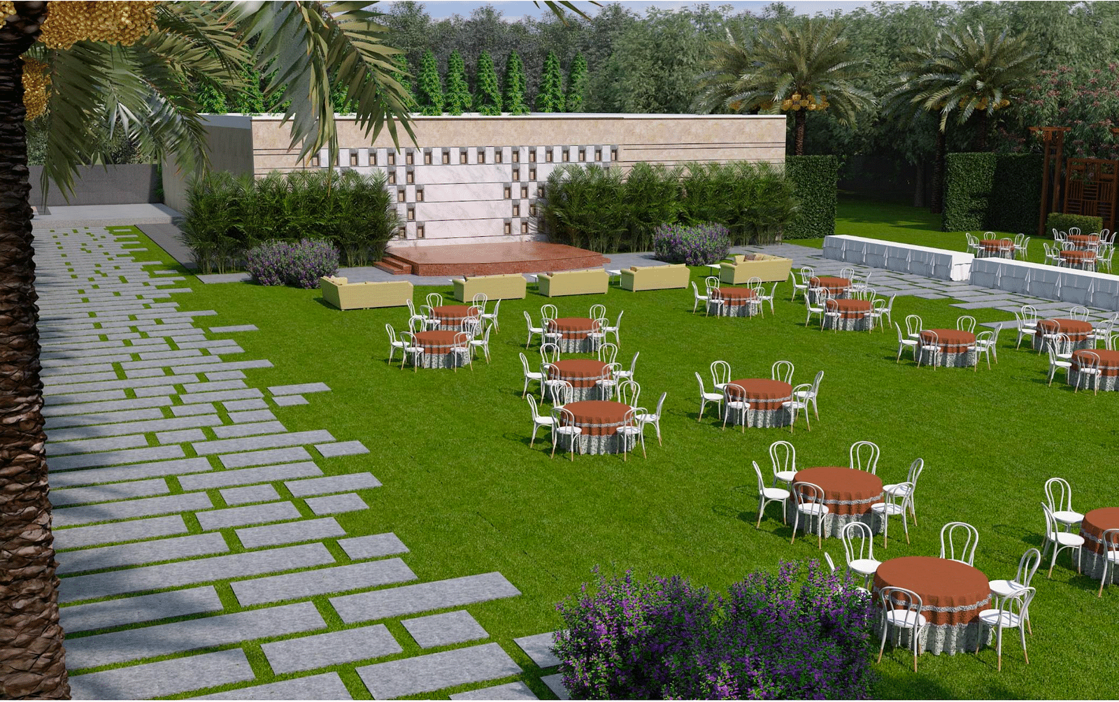 A wide view of lawn with stage, tables, and chairs on grass, stone pathways on either side, and palm trees around the area at Merlis Hotel, Coimbatore