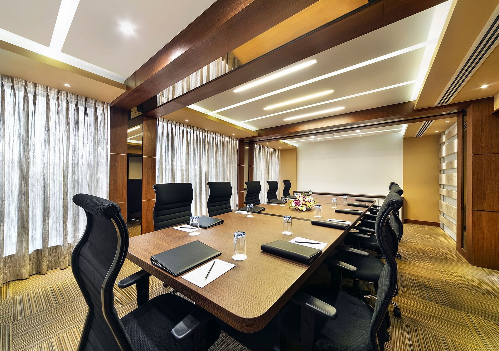 image of a boardroom with a projector at Grand Kakinada by GRT Hotels