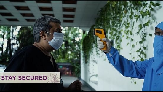 a person wearing a ppe kit and sanitizing the hotel at orchid hotel mumbai vile parle