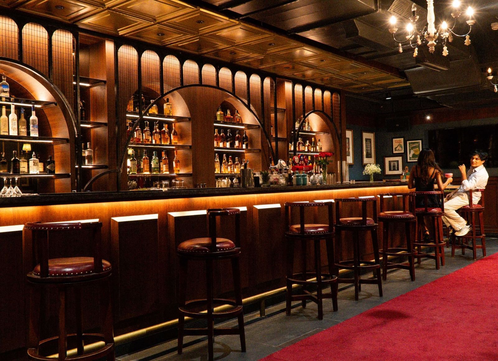 Elegant bar at Mango Hill Central Chennai with warm lighting, premium liquor display, and cozy seating for a relaxed evening.