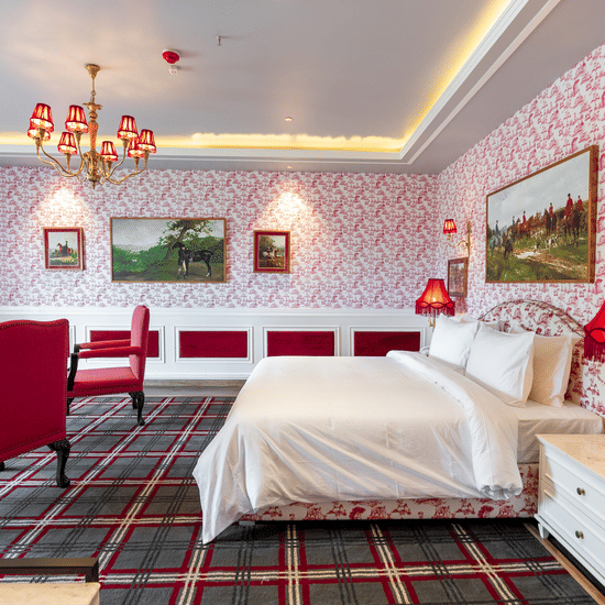 A room with a large bed and two comfy chairs in front of it  - The Manor Luxury Hotel, Shimla