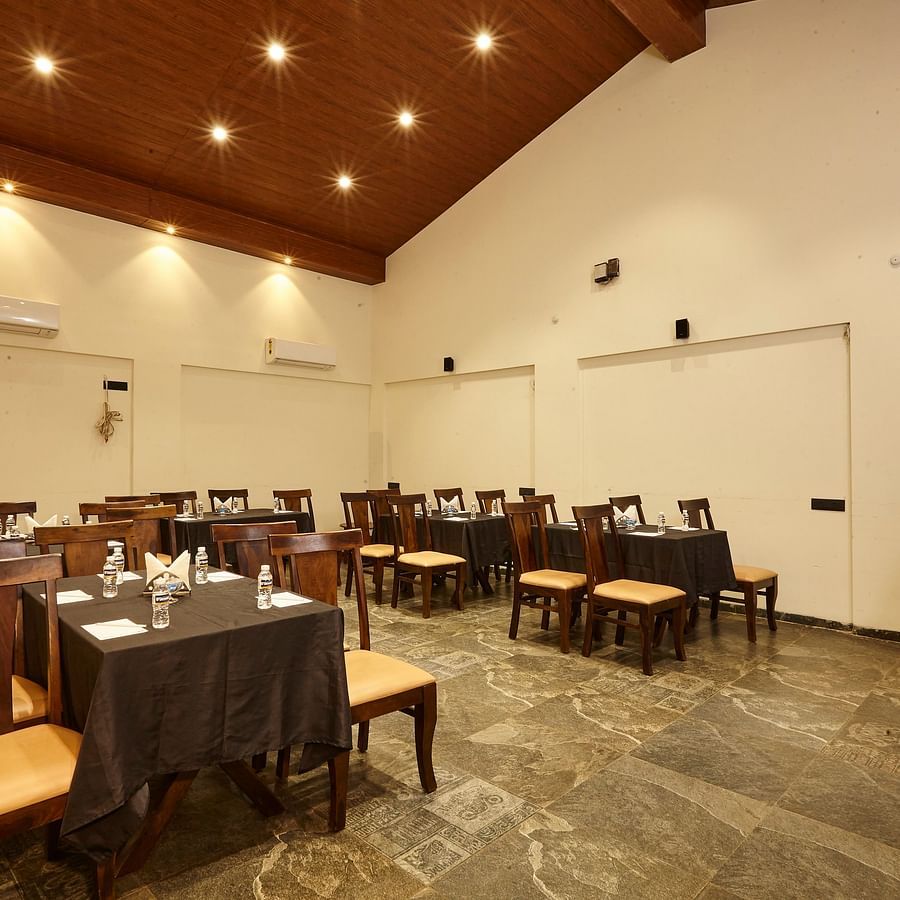 Indoor dining area featuring several tables and chairs arranged for a formal or casual event - Mastiff Grand La Villae Resort, Lonavala