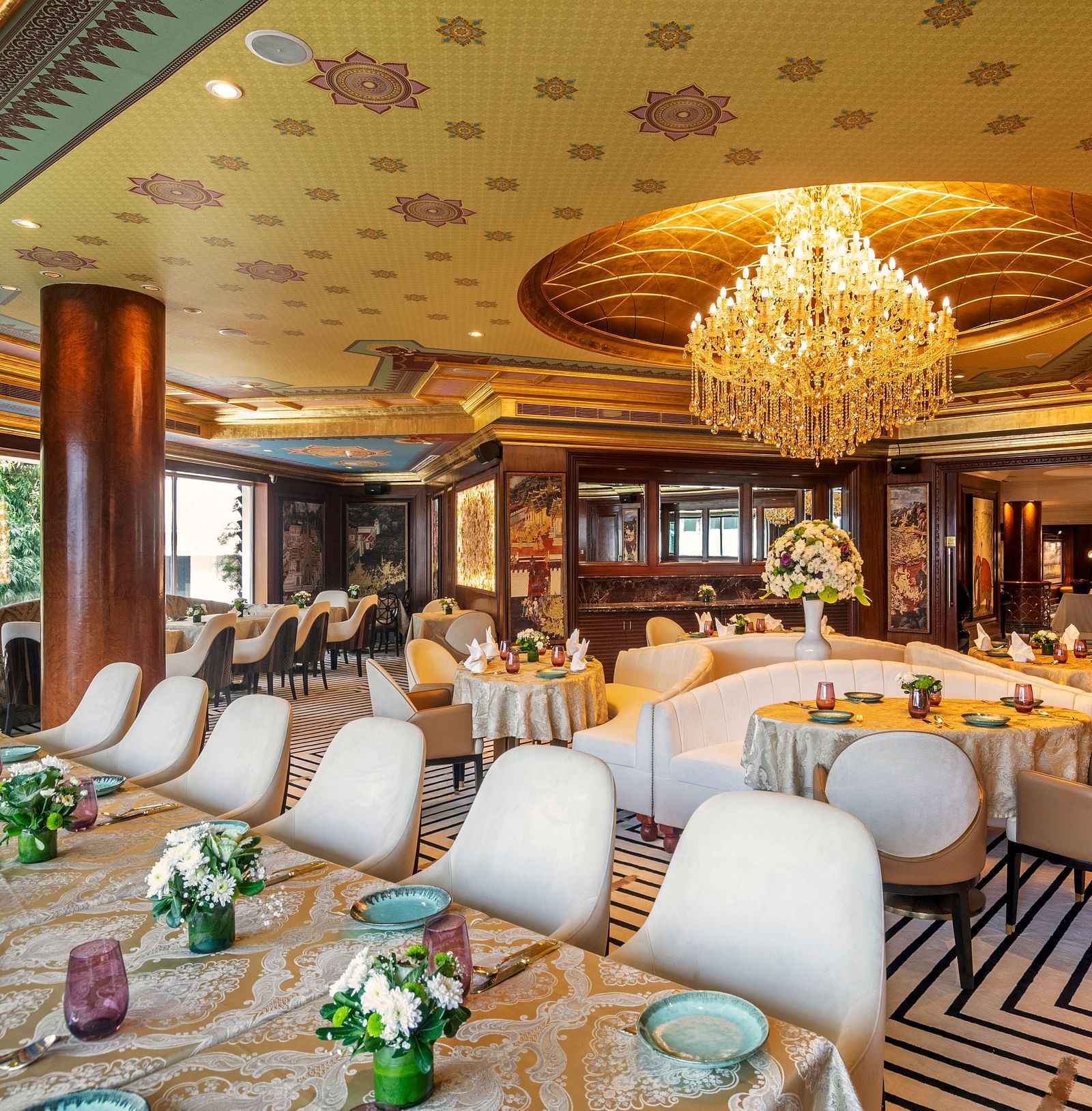 Image of Pickwick Multi-Cuisine Restaurant, featuring a well-decorated dining table surrounded by evenly spaced chairs - The Claridges New Delhi