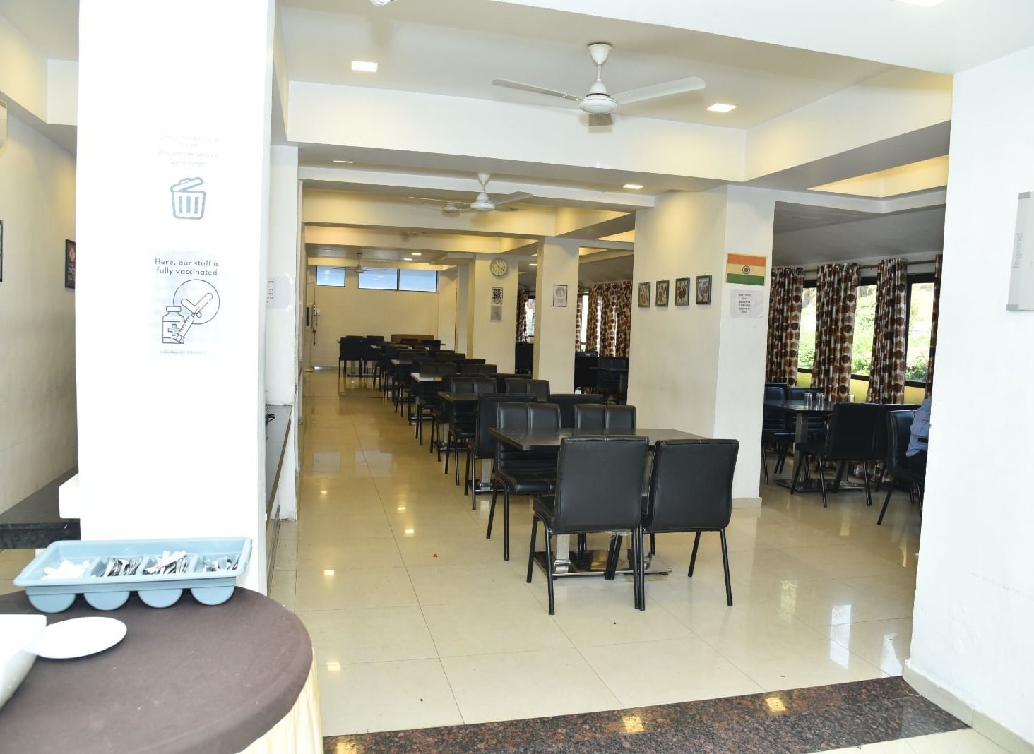 The Darbar Restaurant at Highland Resort features dining tables, and ample lighting.