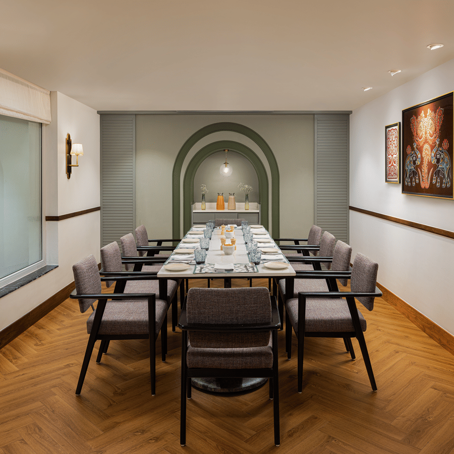 Upscale restaurant buffet area with a large breakfast spread, checkerboard flooring, and modern lighting.