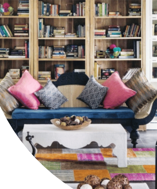 Books stacked in a Library behind a couch