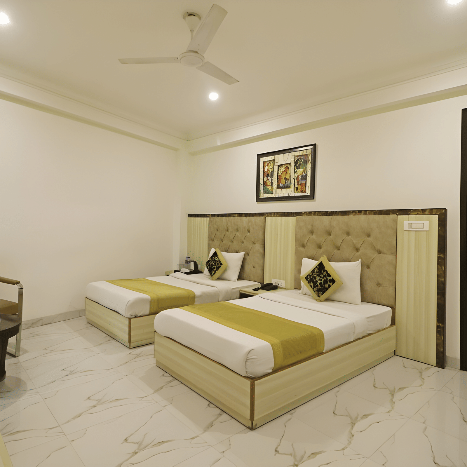 A guest room at Hotel Apple Park Delhi configured with three single beds, white tiled flooring, and a dark wood door