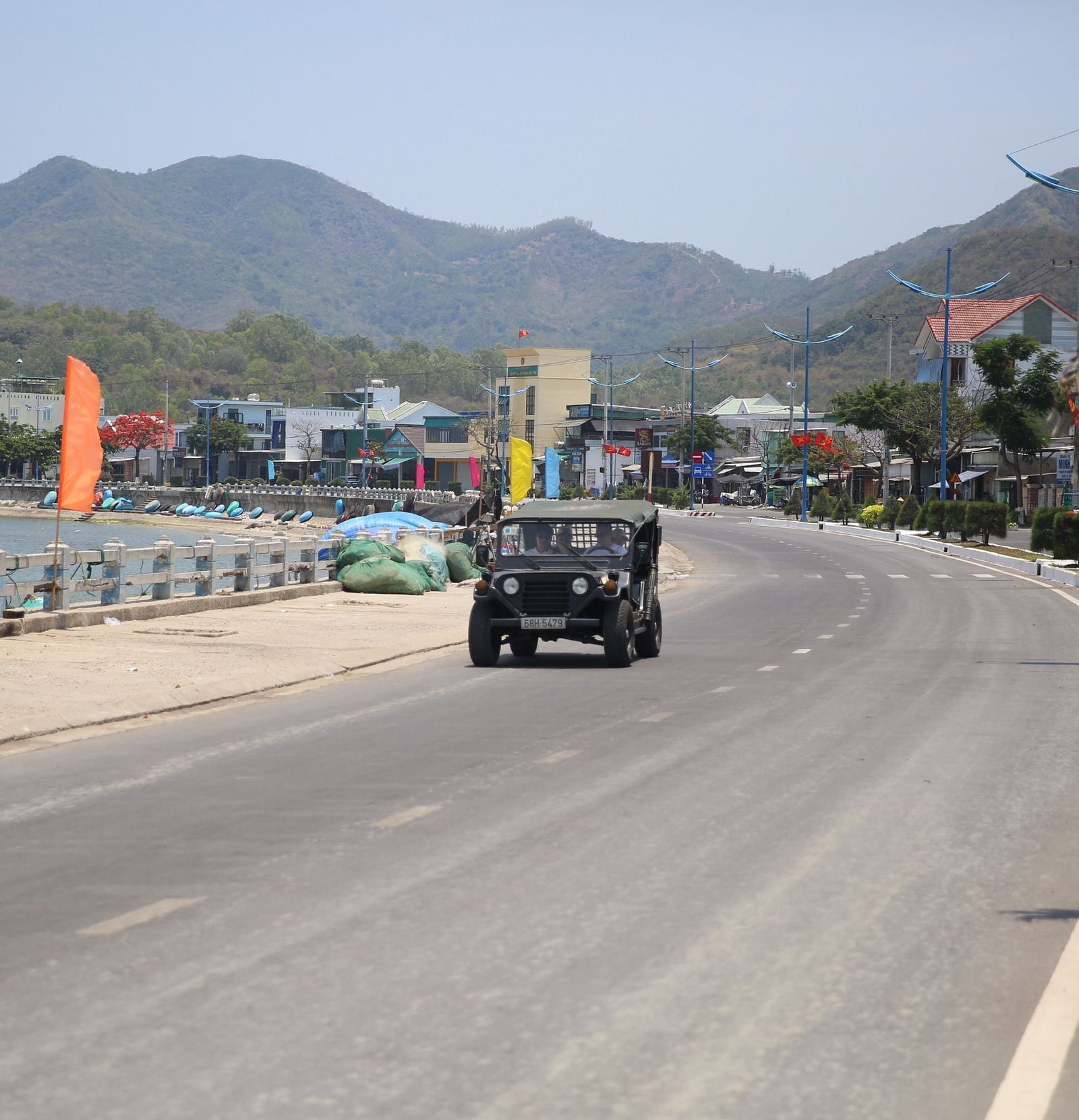 An image of a jeep moving on a road - Alibu Resort Nha Thrang