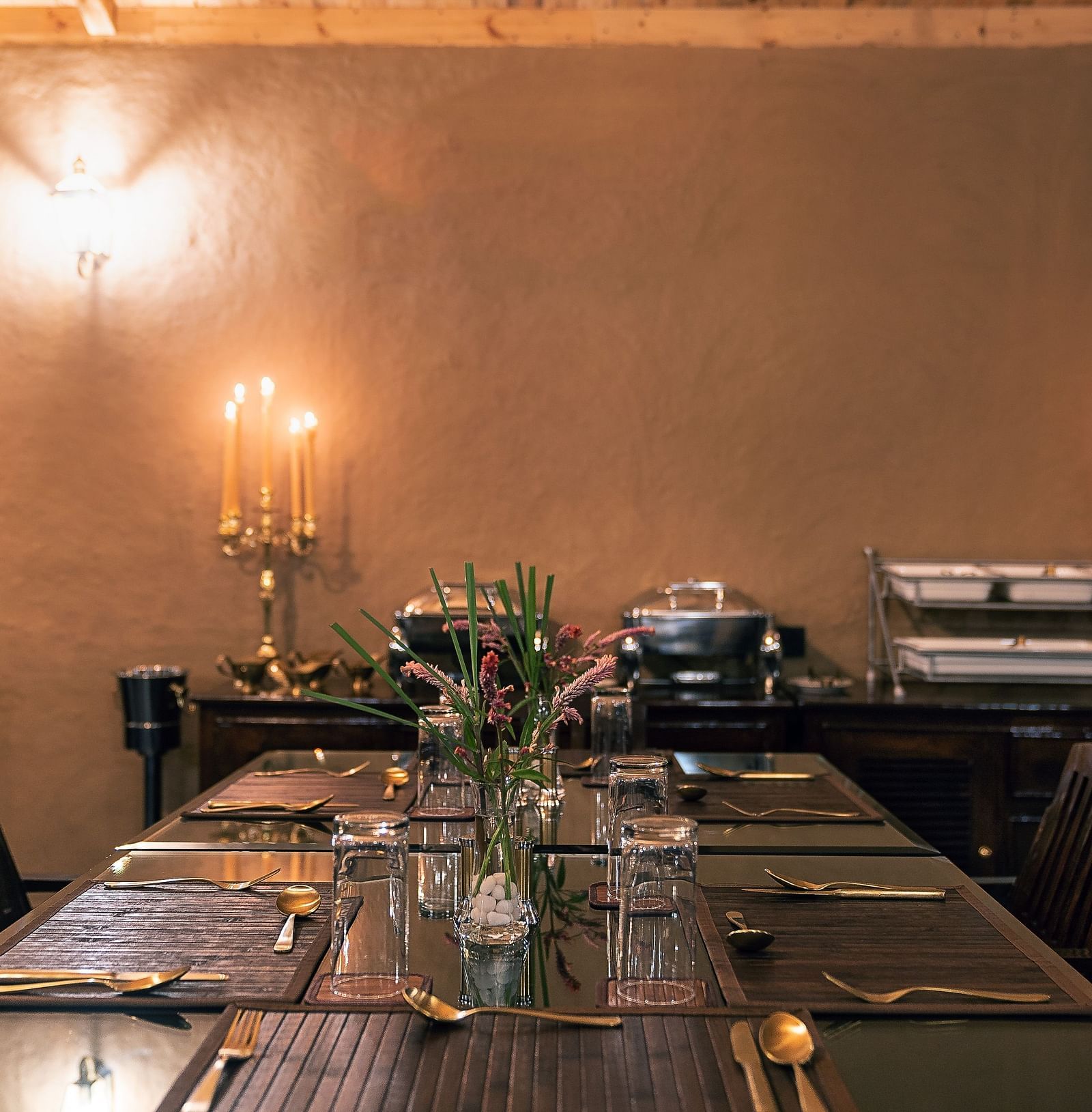 a fine dining setup surrounded by candles at our restaurant near Haridwar - Aalia Jungle Resort & Spa