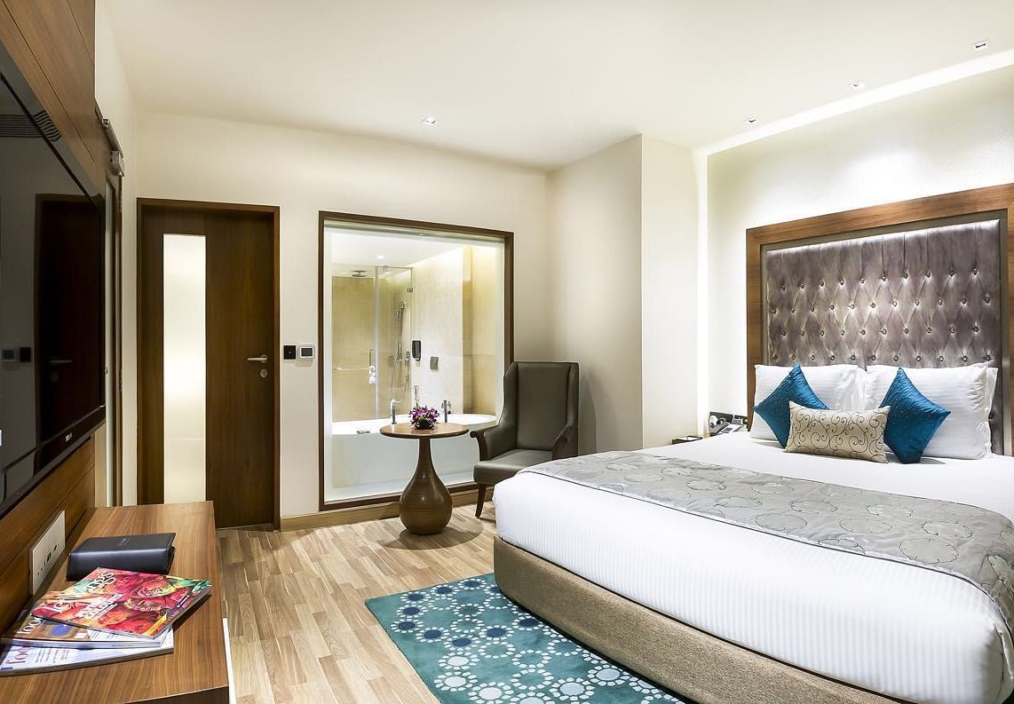 View of the king size bed of a Deluxe Suite at at Grand Chennai By GRT Hotels.
