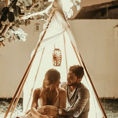 a couple siting in a tent