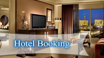 A room interior with a bed, sofa, chairs, table and TV showing a hotel booking sign.