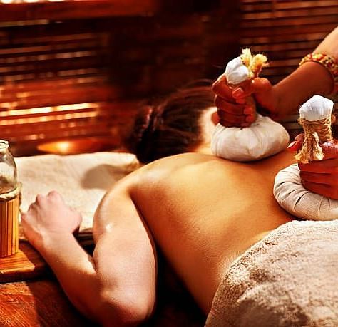 a Women getting a massage in the spa at Ocean Spray Puducherry 