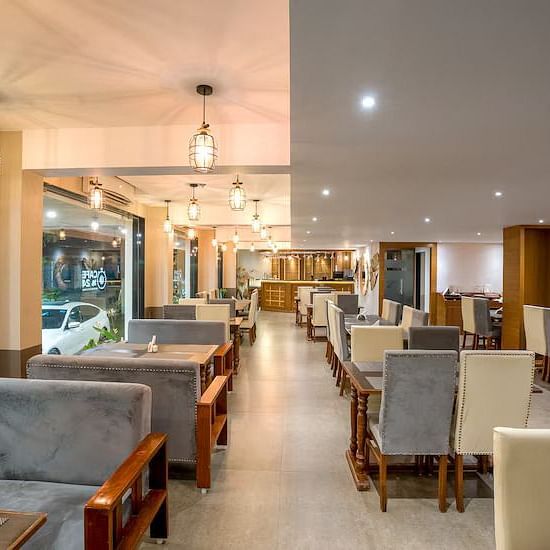 Image of M Cafe with sofa and tables at Vagator Downtown, Goa
