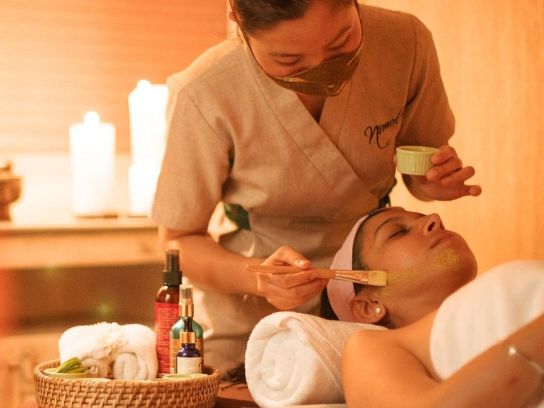 Woman lying on a bed for Spa at Karma Chalets.