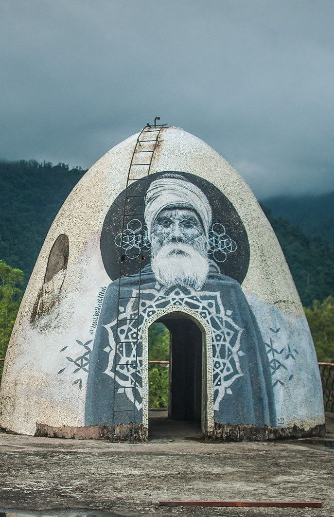 Image of Beatles Ashram with greenery at the bakcground