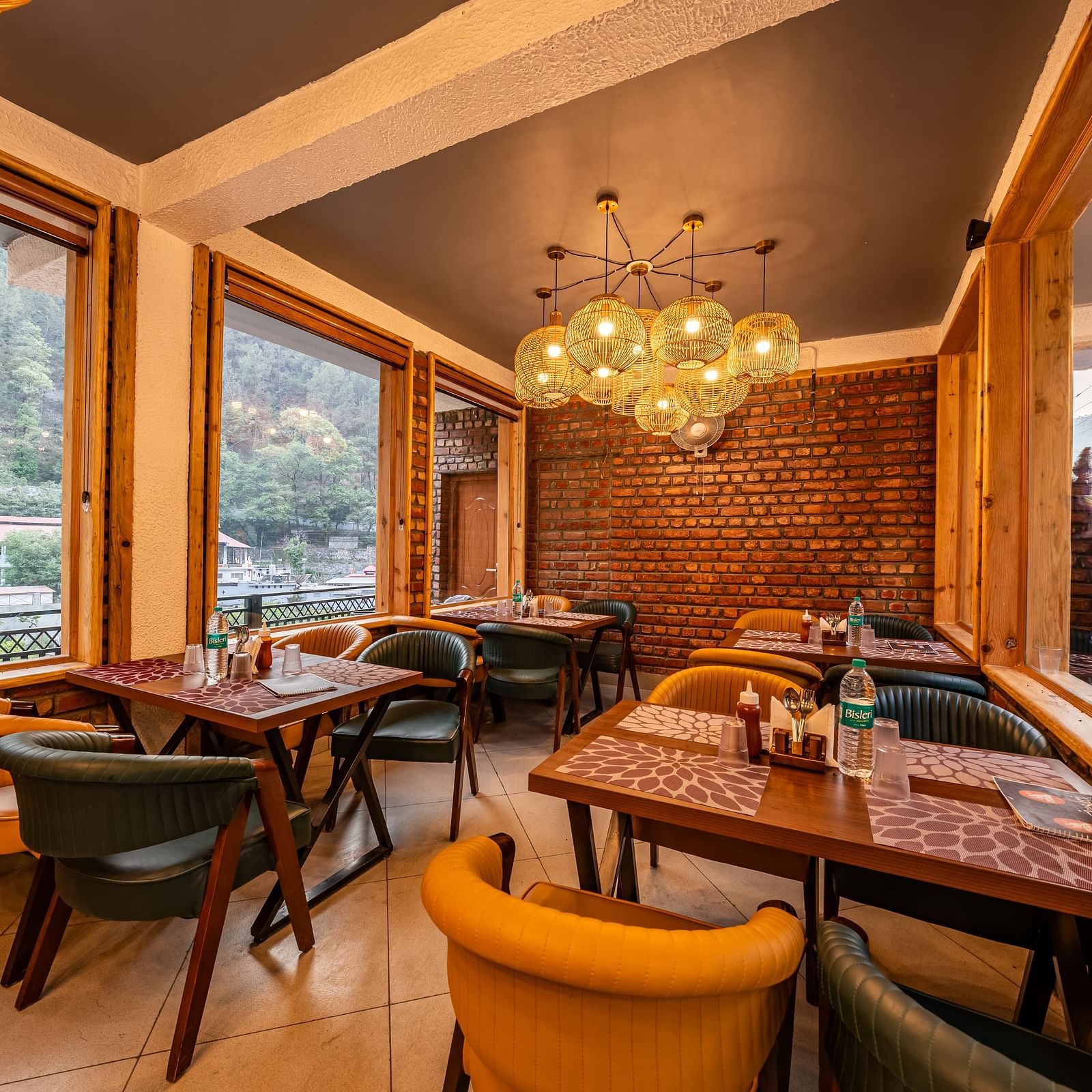 Corner view of the Kesari Restaurant by JVR Stays featuring a chandelier hanging from the ceiling.