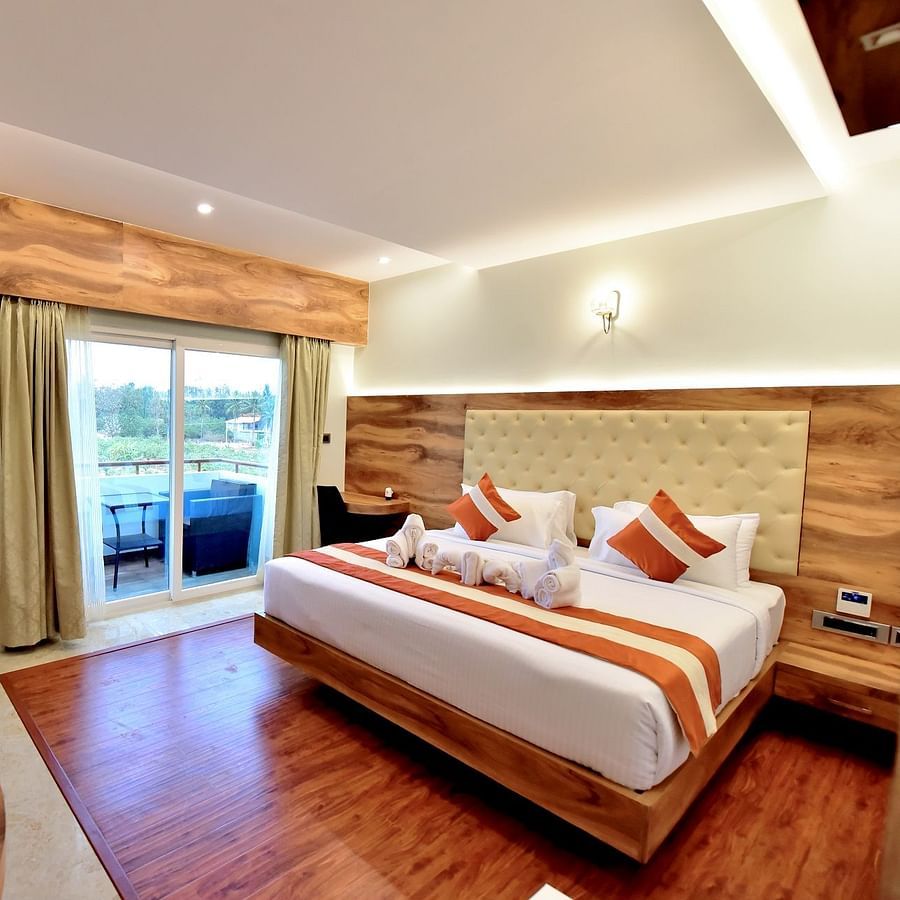 full view of deluxe room with in-room amenities like a television air-conditioning an open balcony and more - Royal Lotus View Resotel