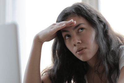 A young lady in despair after answering phone queries.