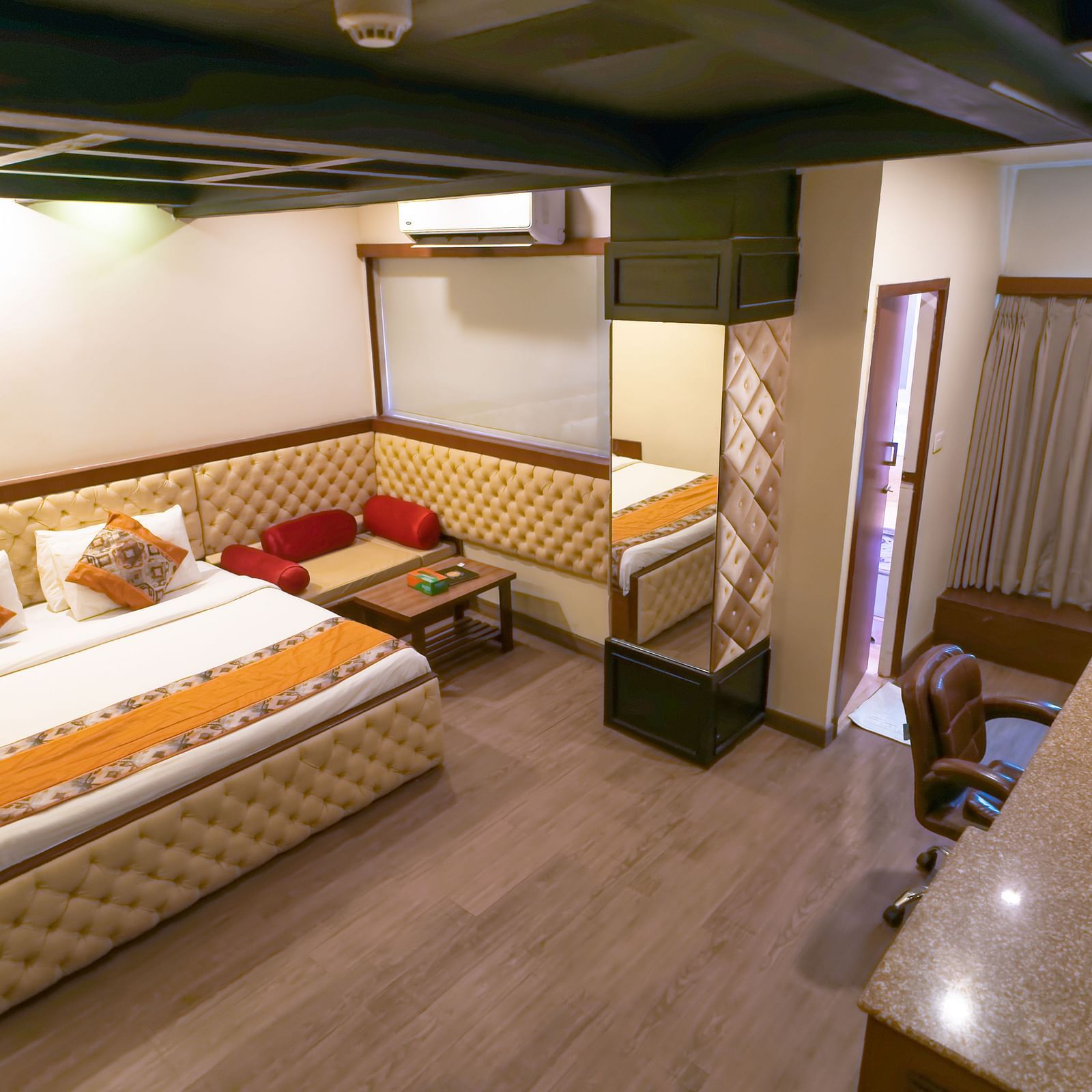 A view of the Deluxe Room featuring a bed with wooden interior at Hotel Ashok Nagpur.