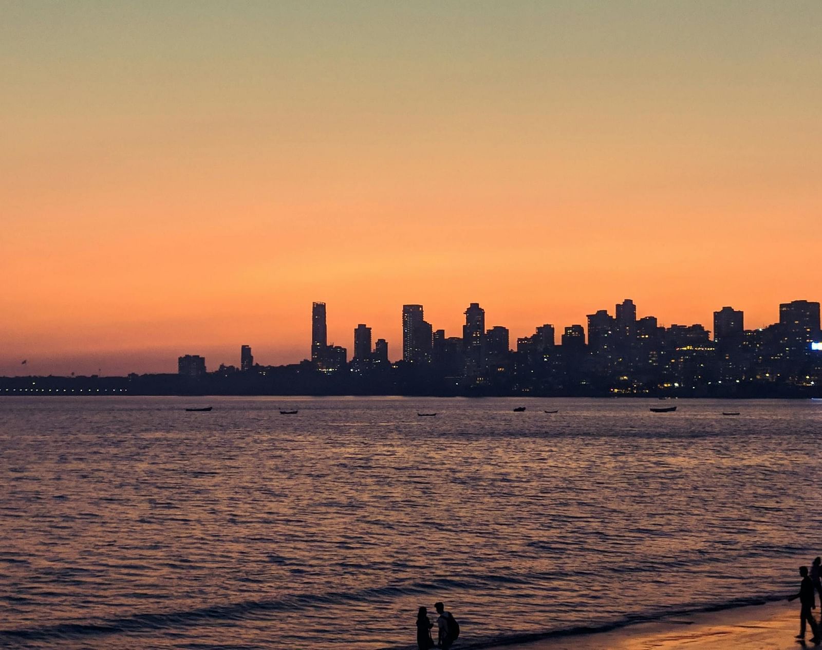 Image of the Arabian Sea with buildings along the coastline.