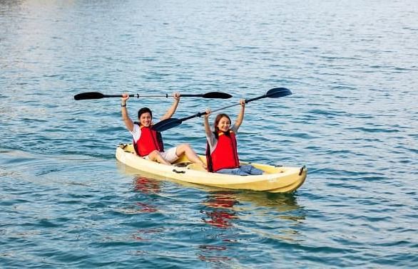 An image of two people boating in a lake - Alibu Resort Nha Thrang