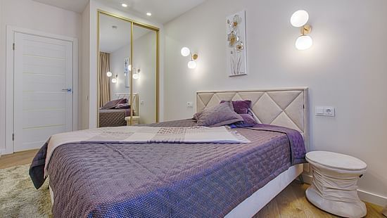 Luxury room with a double bed and purple bedsheet @ Lamrin Ucassaim Hotel, Goa