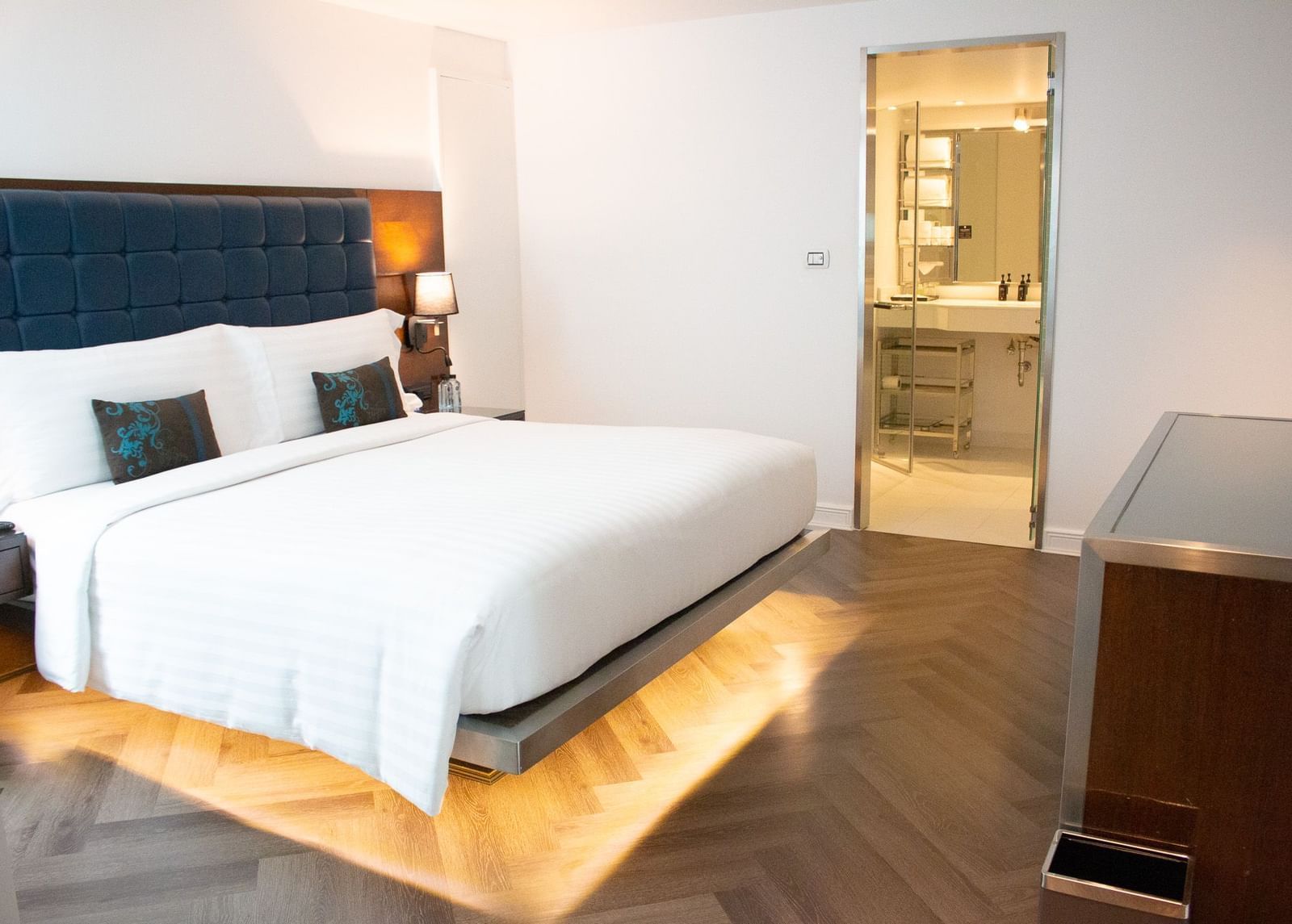 Bedroom at Night Hotel Bangkok with king bed and warm ambient lighting.