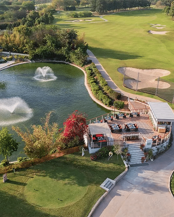 Aerial view of Karma Chalets’ landscaped grounds with fountains, greenery, and outdoor seating.
