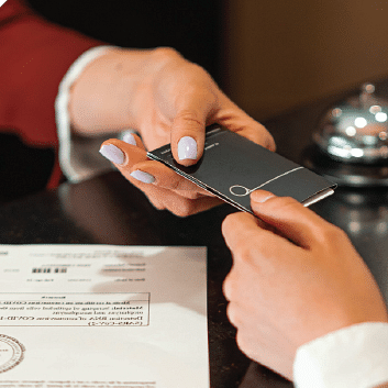 image of a receptionist handing over a card to a person