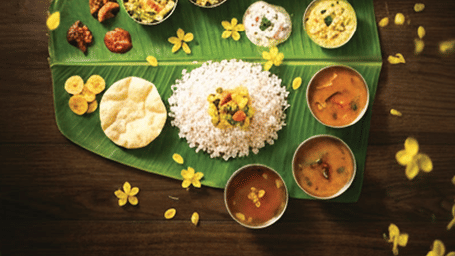 Vishu Sadhya promotional banner featuring traditional Kerala meal served on a banana leaf with festive presentation