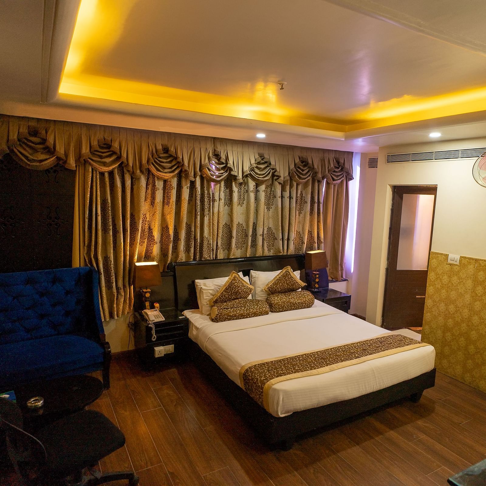 A large bed in a Deluxe Room at Hotel Ashok Nagpur.