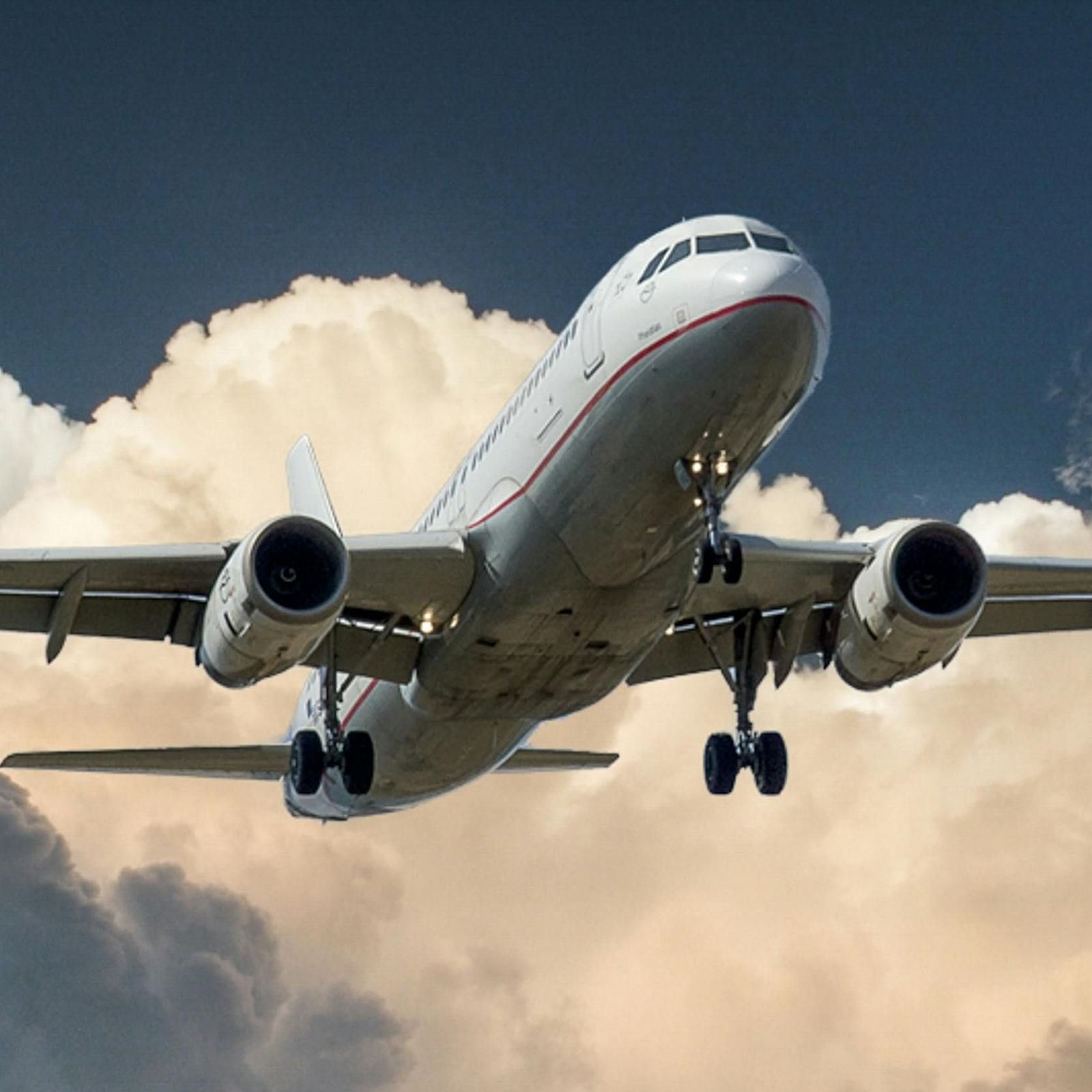 An aeroplane soaring through a heavily clouded sky