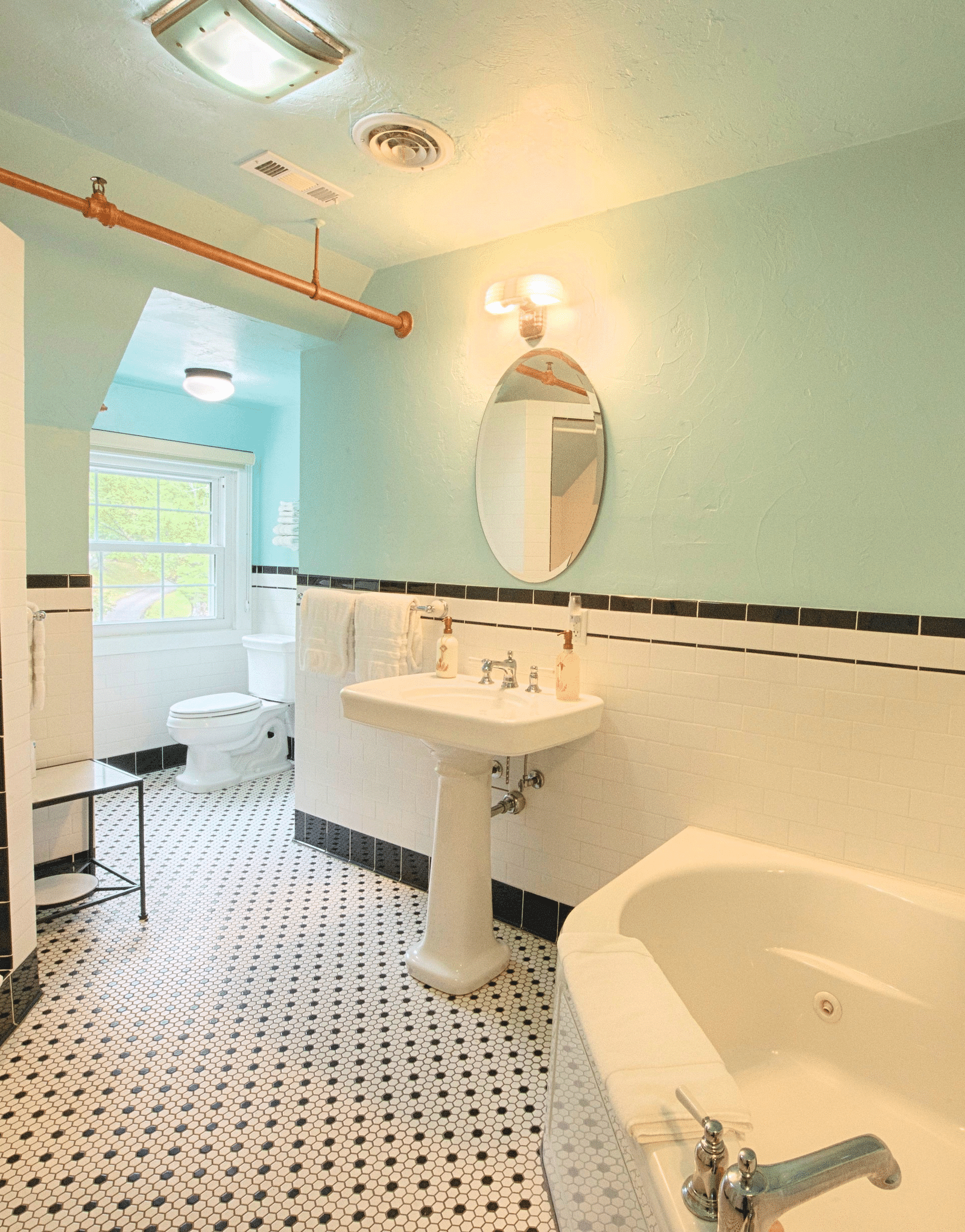 a chic and modern bathroom at the laurel suite featuring a big bath tub along with a shower cubical and a wash basin - Historic Tapoco Lodge
