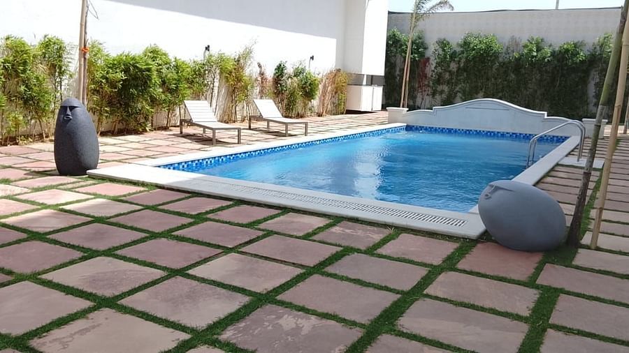 The pool area at Clarks Inn Express, Firozabad, that features lounge chairs and a pool.