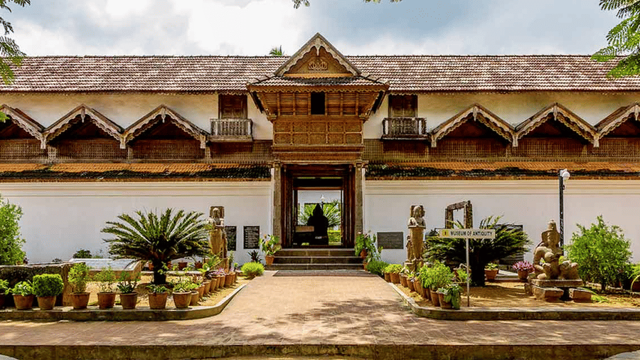 A heritage-style building with ornate wooden details and a landscaped entrance.