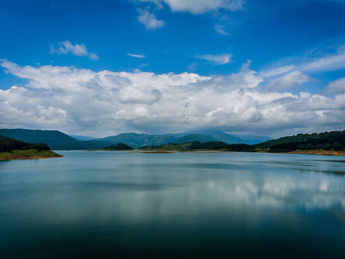 a beautiful view of a lake with hills outlining it